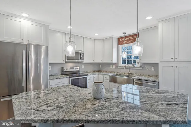 a kitchen with a refrigerator a sink and cabinets