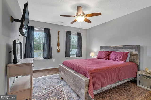 a bedroom with a bed and a large mirror with dresser
