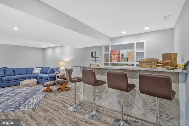 a living room with couches and kitchen view