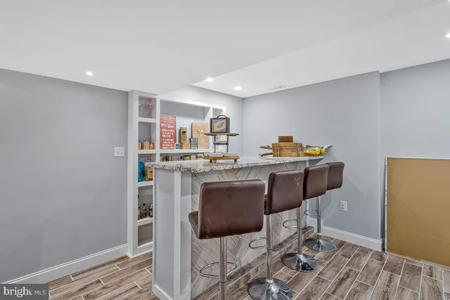 a kitchen with stainless steel appliances granite countertop a sink and a refrigerator