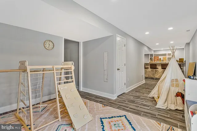 a view of a hall with wooden floor and white walls