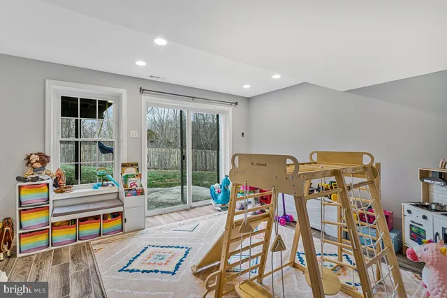 a bedroom with furniture and a floor to ceiling window