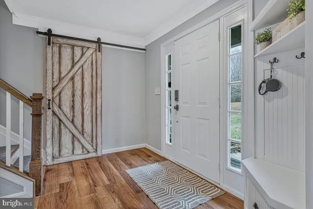 a view of walk in closet with wooden floor and stairs