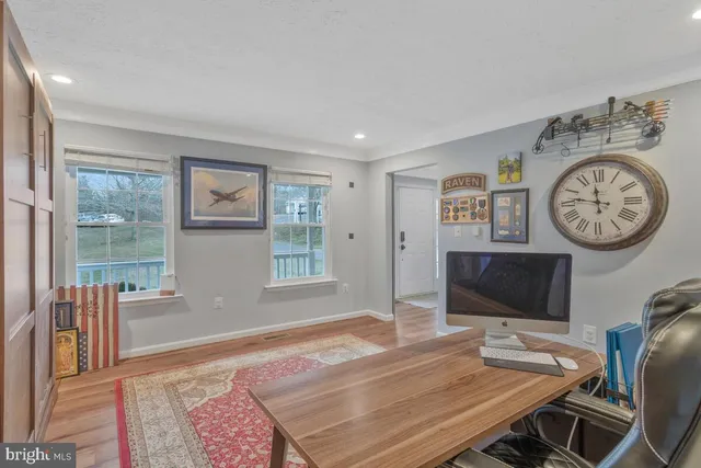 a bedroom with a bed a mirror and a window