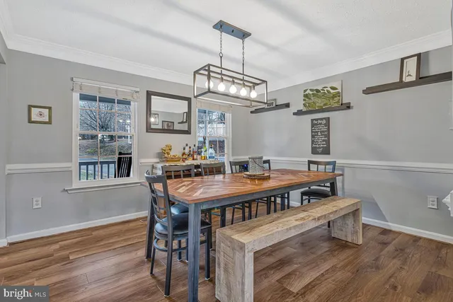 a view of a dining room with furniture wooden floor and chandelier