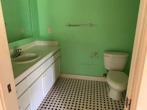 5004 A Awawa Road Eleele, HI 96705 - Photo 15 of 24 a bathroom with a granite countertop toilet and a sink