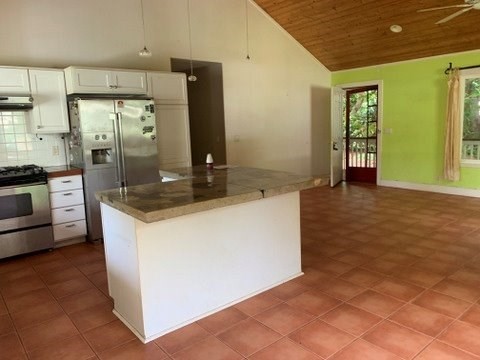 5004 A Awawa Road Eleele, HI 96705 - Photo 3 of 24 a kitchen with stainless steel appliances granite countertop a refrigerator and a stove