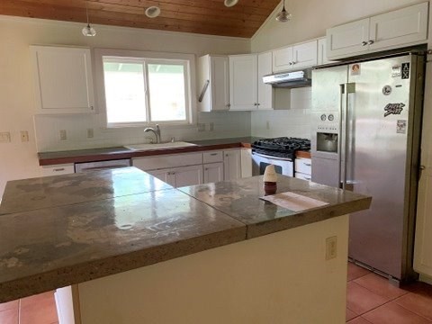 5004 A Awawa Road Eleele, HI 96705 - Photo 5 of 24 a kitchen with stainless steel appliances granite countertop a sink a stove and a refrigerator
