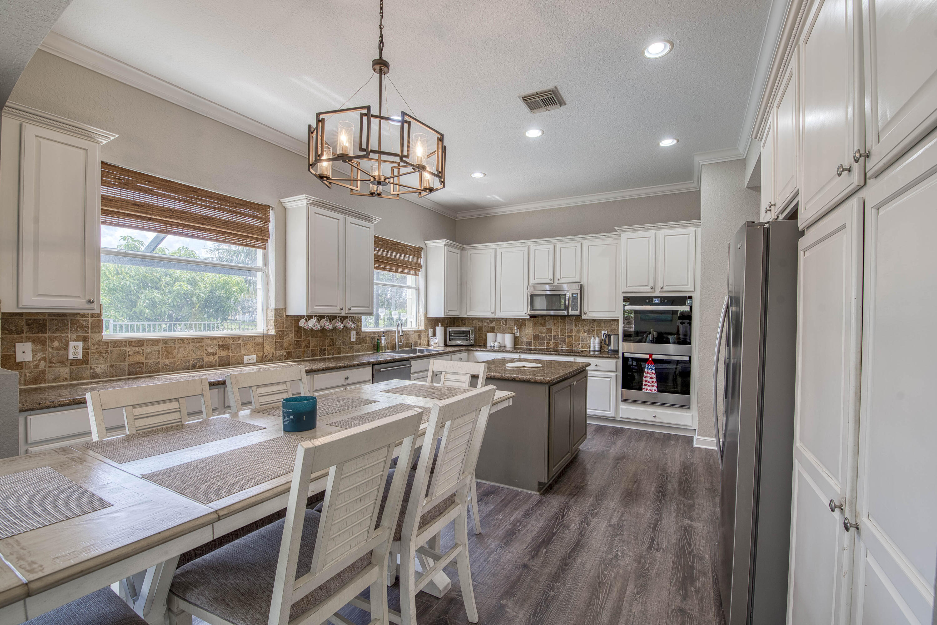 410 Cresta Circle West Palm Beach, FL 33413 - Photo 15 of 46 a kitchen with refrigerator a stove and wooden floor