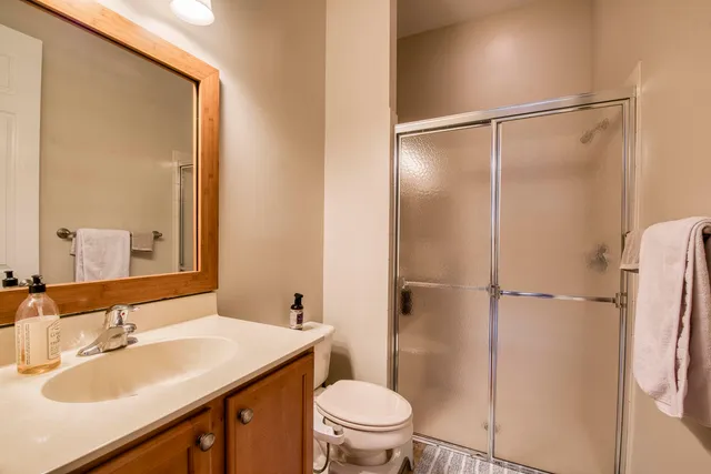 a bathroom with a sink toilet and shower