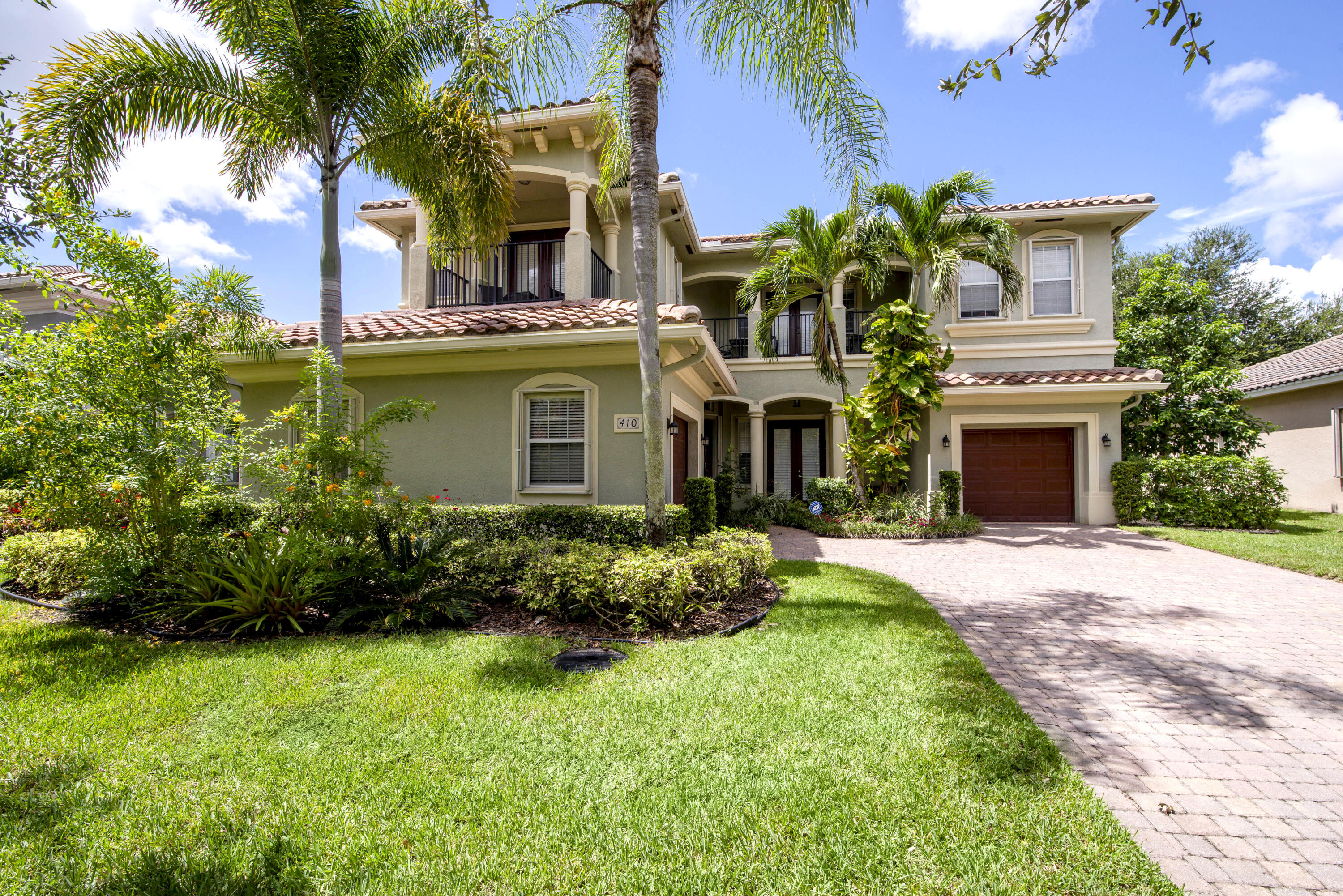 410 Cresta Circle West Palm Beach, FL 33413 - Photo 2 of 46 a front view of a house with a garden