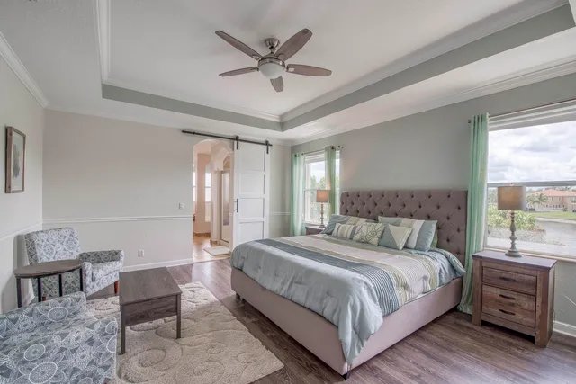 a bedroom with a bed a couch and window