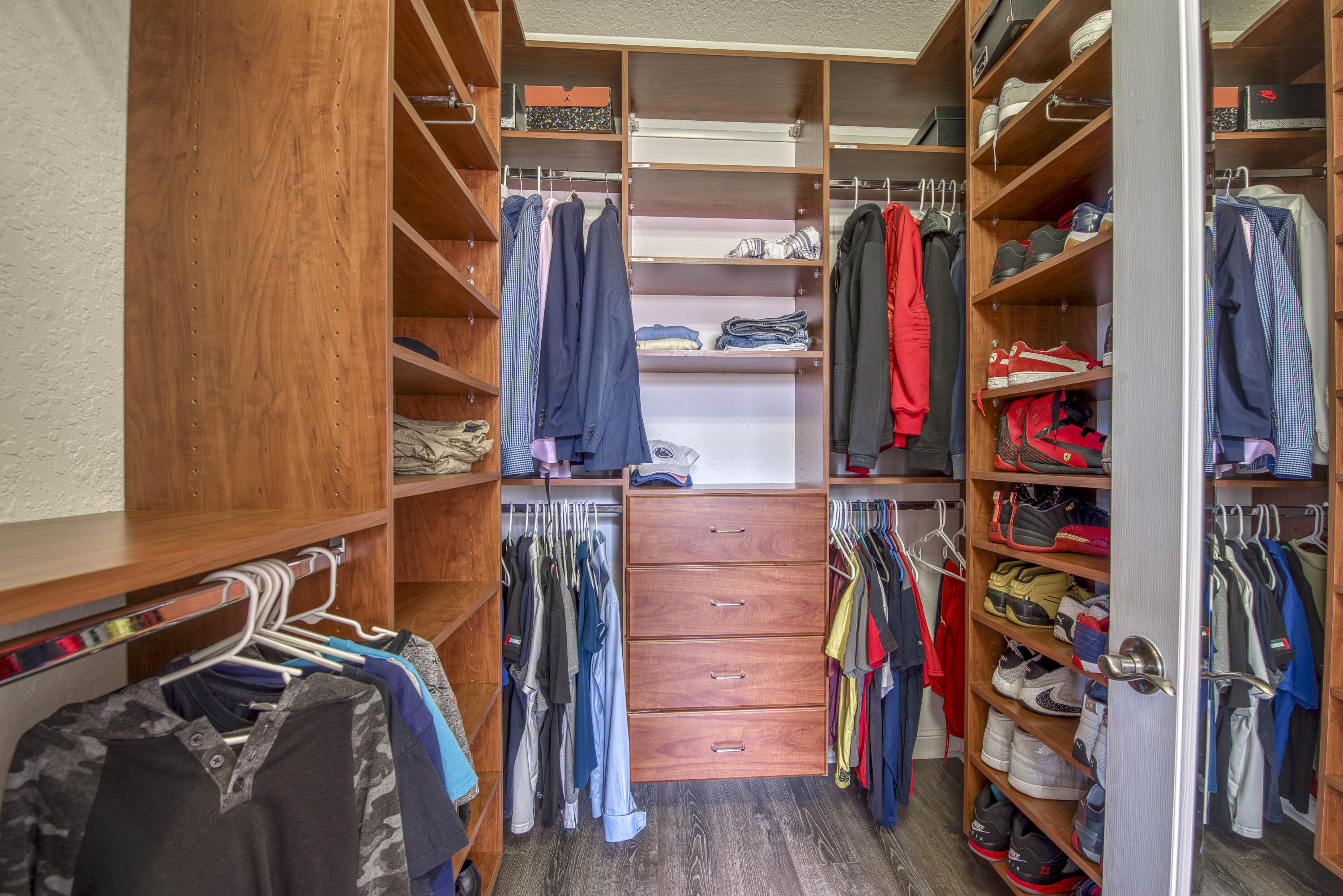410 Cresta Circle West Palm Beach, FL 33413 - Photo 28 of 46 a view of walk in closet with clothes and shoes