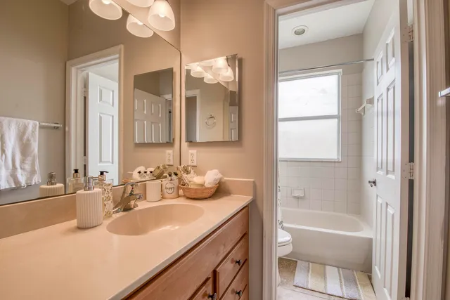 a bathroom with a tub sink and mirror