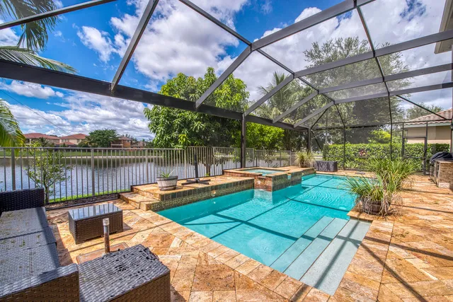 a view of swimming pool with a patio and a yard