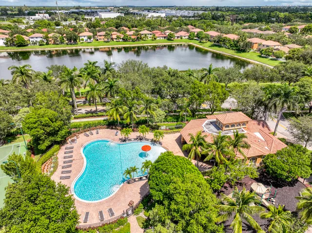 an aerial view of lake residential house with outdoor space and trees all around