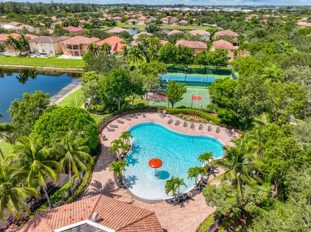 an aerial view of a swimming pool a yard and lake view