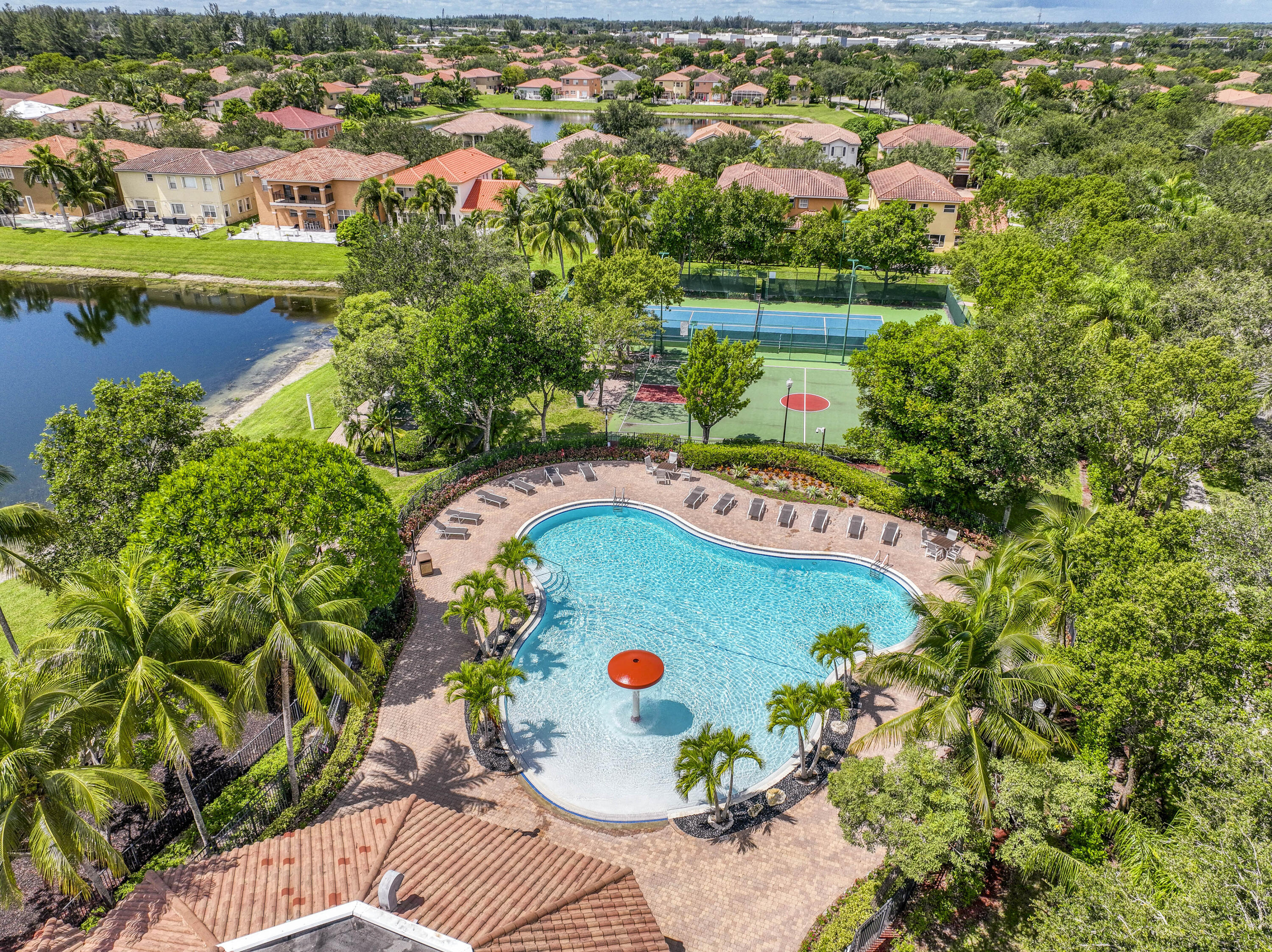 410 Cresta Circle West Palm Beach, FL 33413 - Photo 41 of 46 an aerial view of a swimming pool a yard and lake view