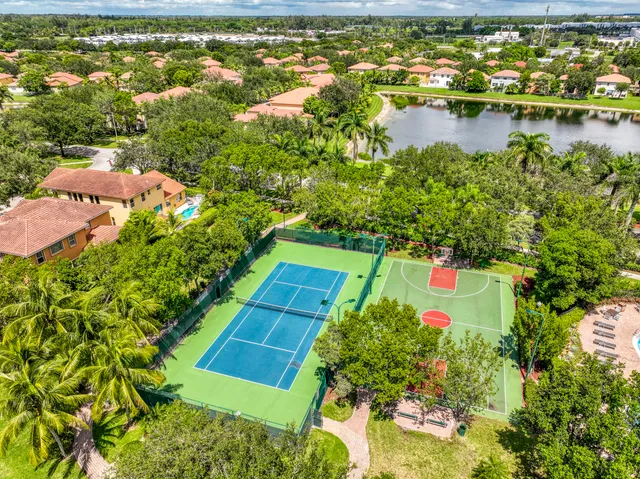 an aerial view of residential houses with outdoor space and lake view
