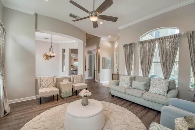 a living room with furniture and a chandelier