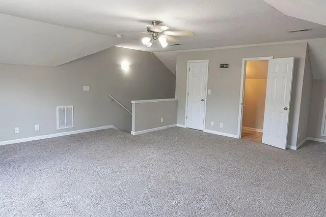 a view of a livingroom with a ceiling fan and window
