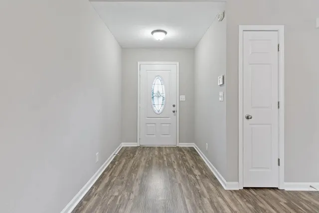 a view of a room with wooden floor