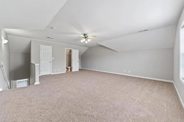 a view of an empty room with a ceiling fan