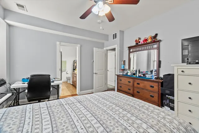 a bedroom with a bed and a dresser in it