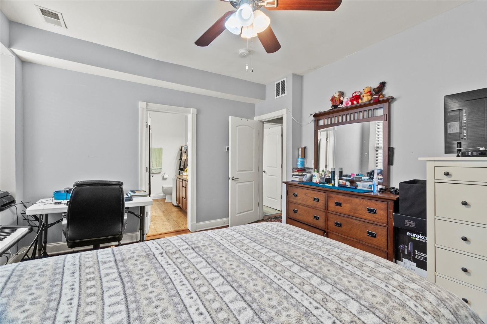 6414 North Hoyne Avenue, Unit 3W Chicago, IL 60645 - Photo 11 of 16 a bedroom with a bed and a dresser in it