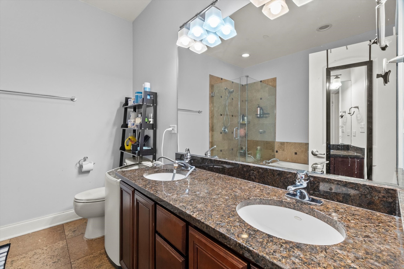 6414 North Hoyne Avenue, Unit 3W Chicago, IL 60645 - Photo 12 of 16 a bathroom with a granite countertop double vanity sink toilet and a mirror
