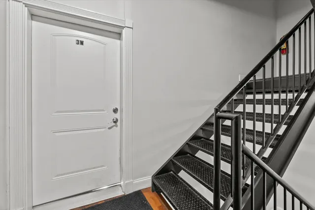 a view of an entryway with wooden floor