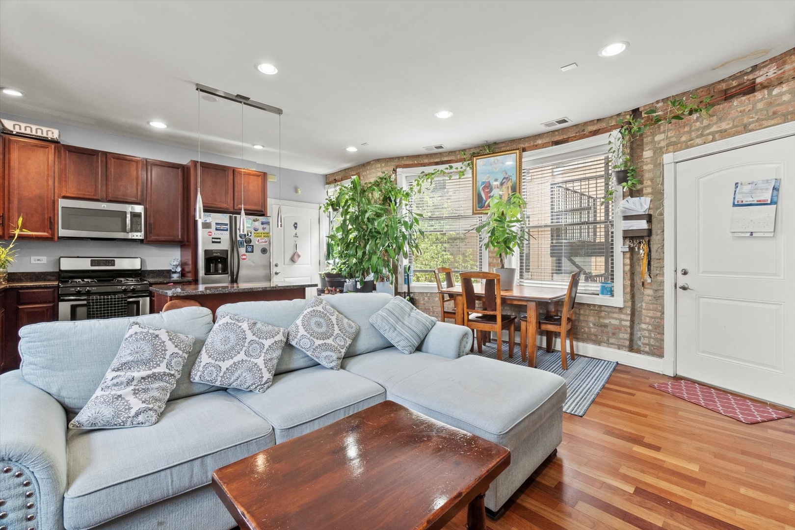6414 North Hoyne Avenue, Unit 3W Chicago, IL 60645 - Photo 6 of 16 a living room with furniture and a flat screen tv