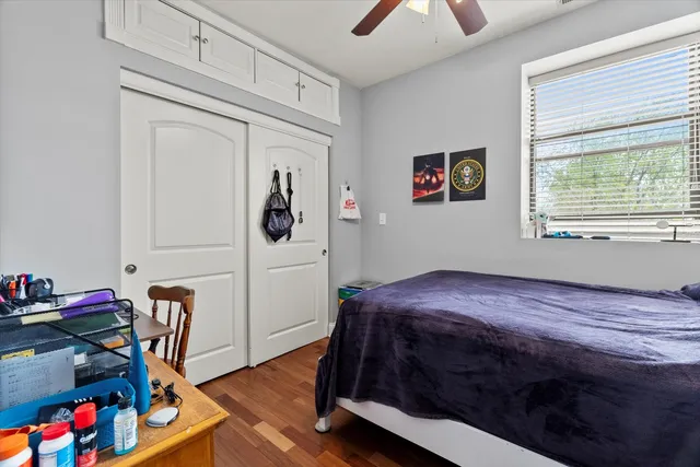 a bedroom with a bed and wooden floor