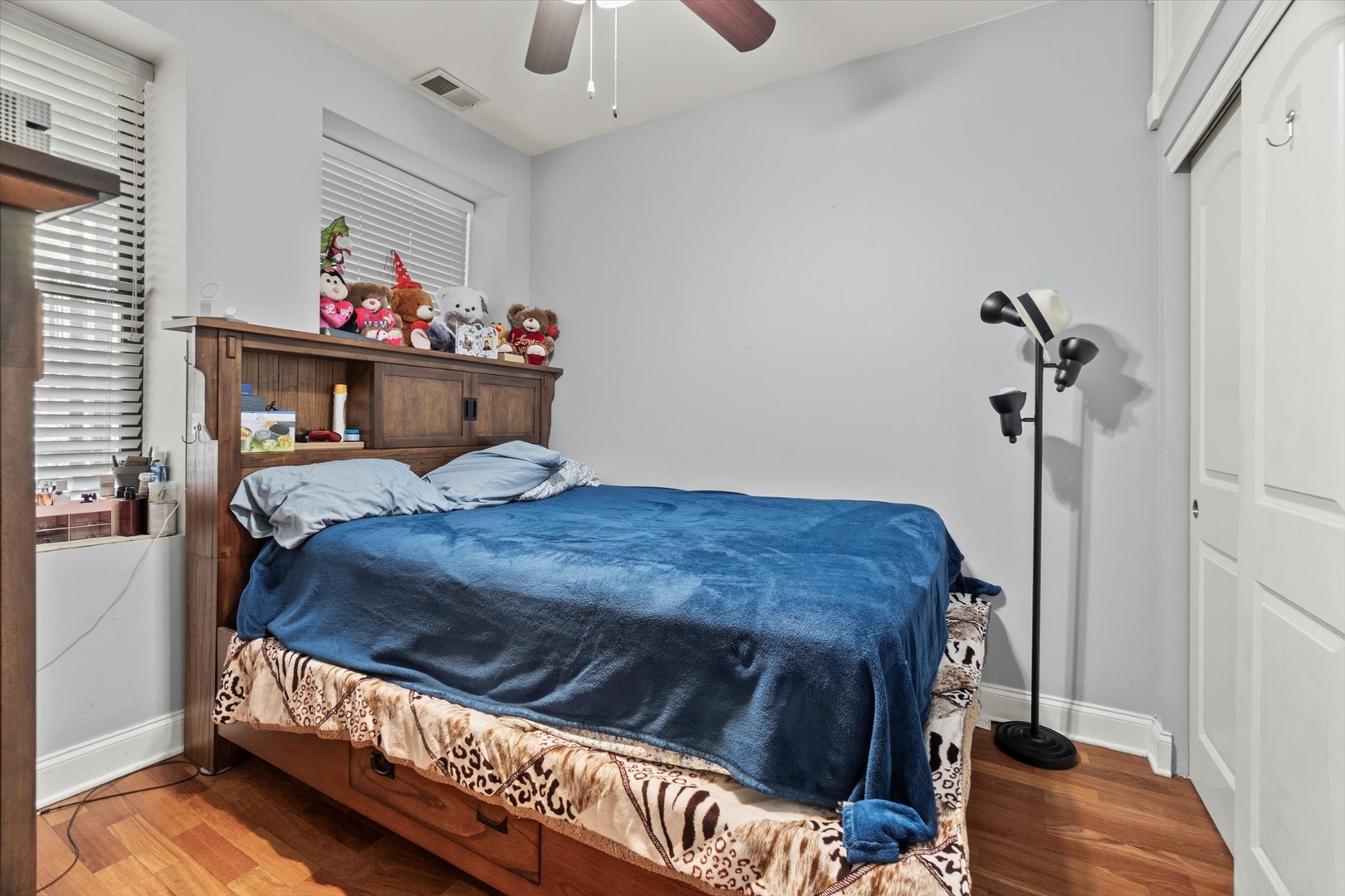 6414 North Hoyne Avenue, Unit 3W Chicago, IL 60645 - Photo 8 of 16 a bedroom with a bed and wooden floor