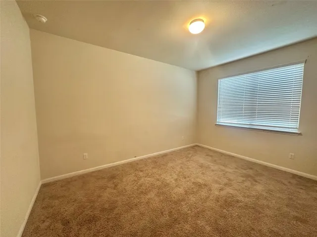 an empty room with a empty space and windows