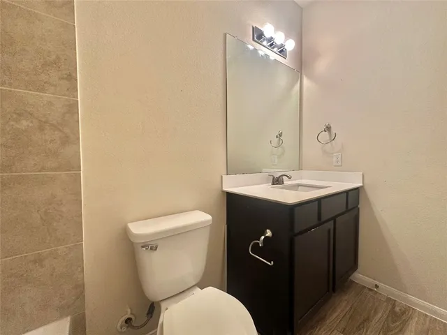 a bathroom with a sink toilet and mirror