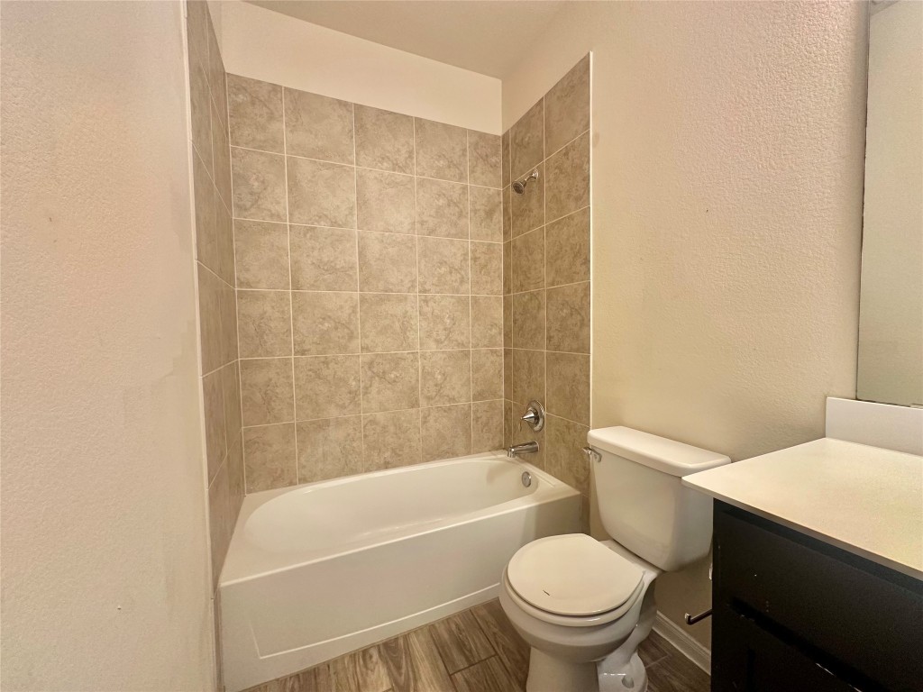 8164 Daisy Cutter Crossing Georgetown, TX 78626 - Photo 17 of 19 a white toilet sitting next to a bath tub