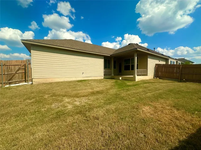 a view of a house with a yard and garage