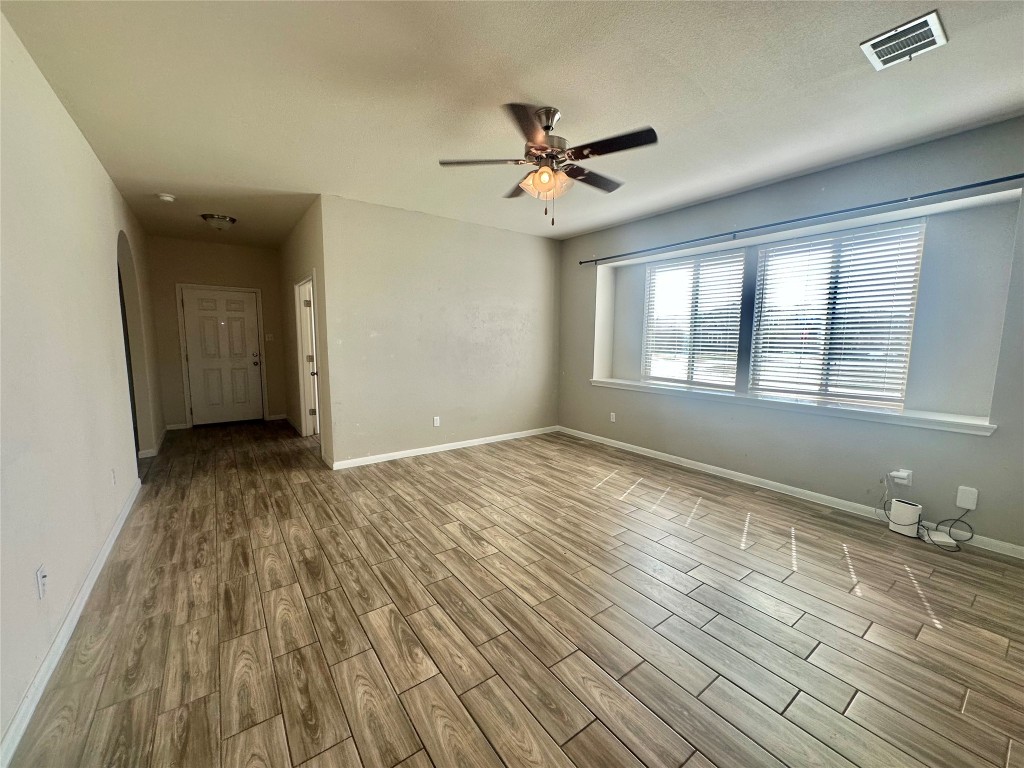 8164 Daisy Cutter Crossing Georgetown, TX 78626 - Photo 6 of 19 a view of empty room with wooden floor and fan