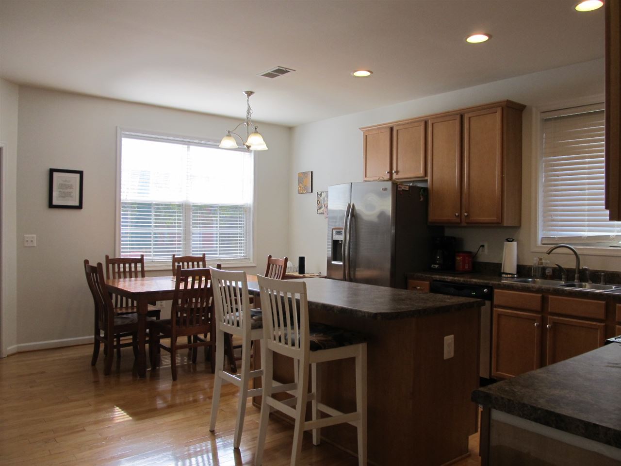 5459 Park Road Crozet, VA 22932 - Photo 8 of 32 a kitchen with stainless steel appliances granite countertop a dining table chairs and a refrigerator