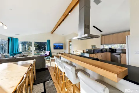 a large kitchen with stainless steel appliances lots of counter space and breakfast area