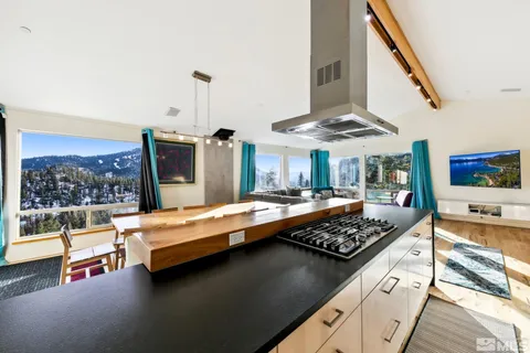 a kitchen with stainless steel appliances granite countertop a stove and a refrigerator