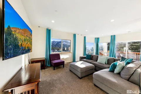 a living room with furniture and a floor to ceiling window