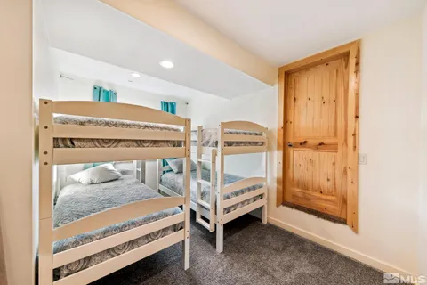 a bedroom with two beds and painted walls