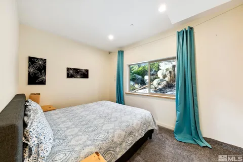 a bedroom with a large bed and a window