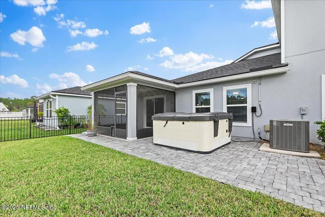 a view of a house with a yard and patio