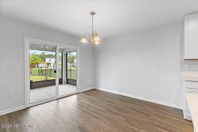 a view of a room with wooden floor water and a faucet