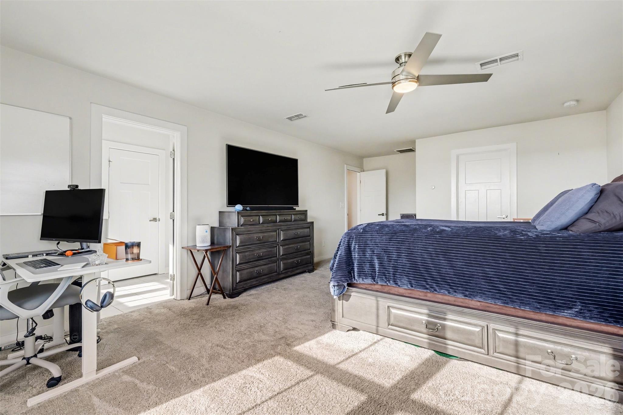 1840 Scarbrough Circle Southwest Concord, NC 28025 - Photo 16 of 29 a bedroom with a bed and a flat screen tv