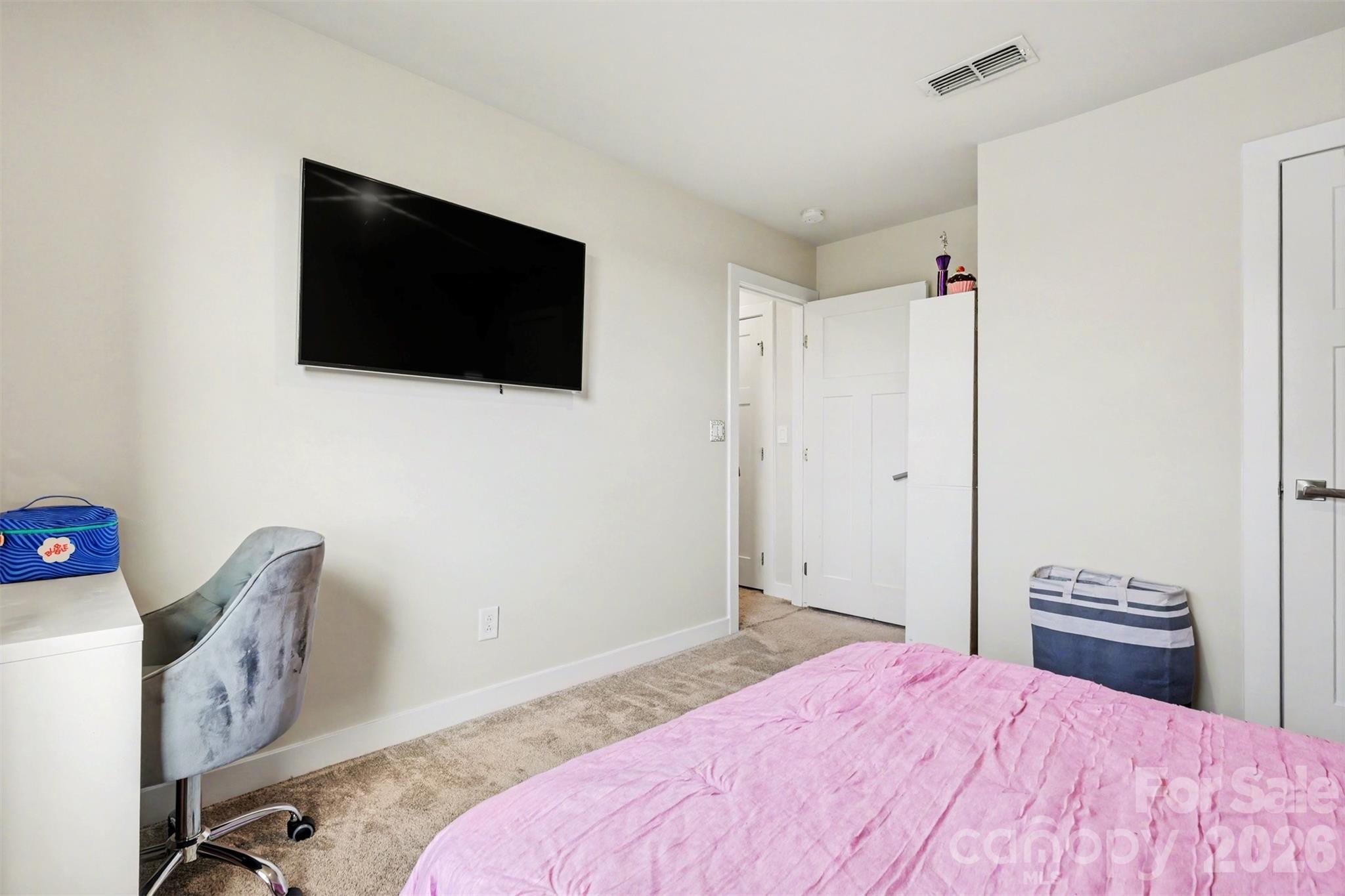 1840 Scarbrough Circle Southwest Concord, NC 28025 - Photo 20 of 29 a bedroom with a bed and a flat screen tv