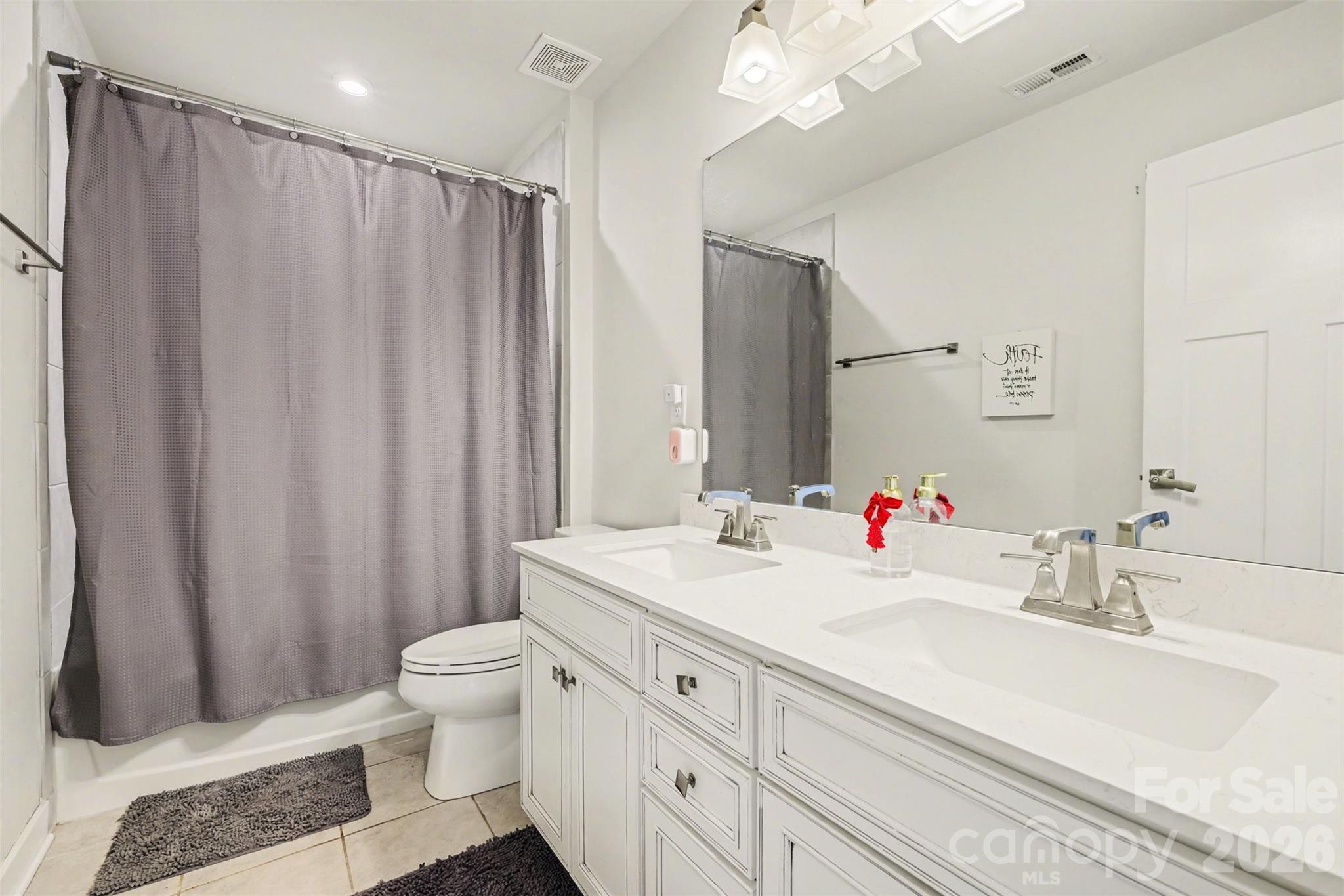 1840 Scarbrough Circle Southwest Concord, NC 28025 - Photo 21 of 29 a bathroom with a double vanity sink toilet and a mirror